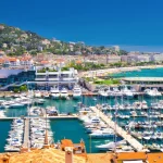 Coastline view on french riviera with yachts in Cannes city center.