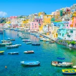 italian island procida is famous for its colorful marina, tiny narrow streets and many beaches which all together attract every year crowds of tourists coming from naples - napoli.